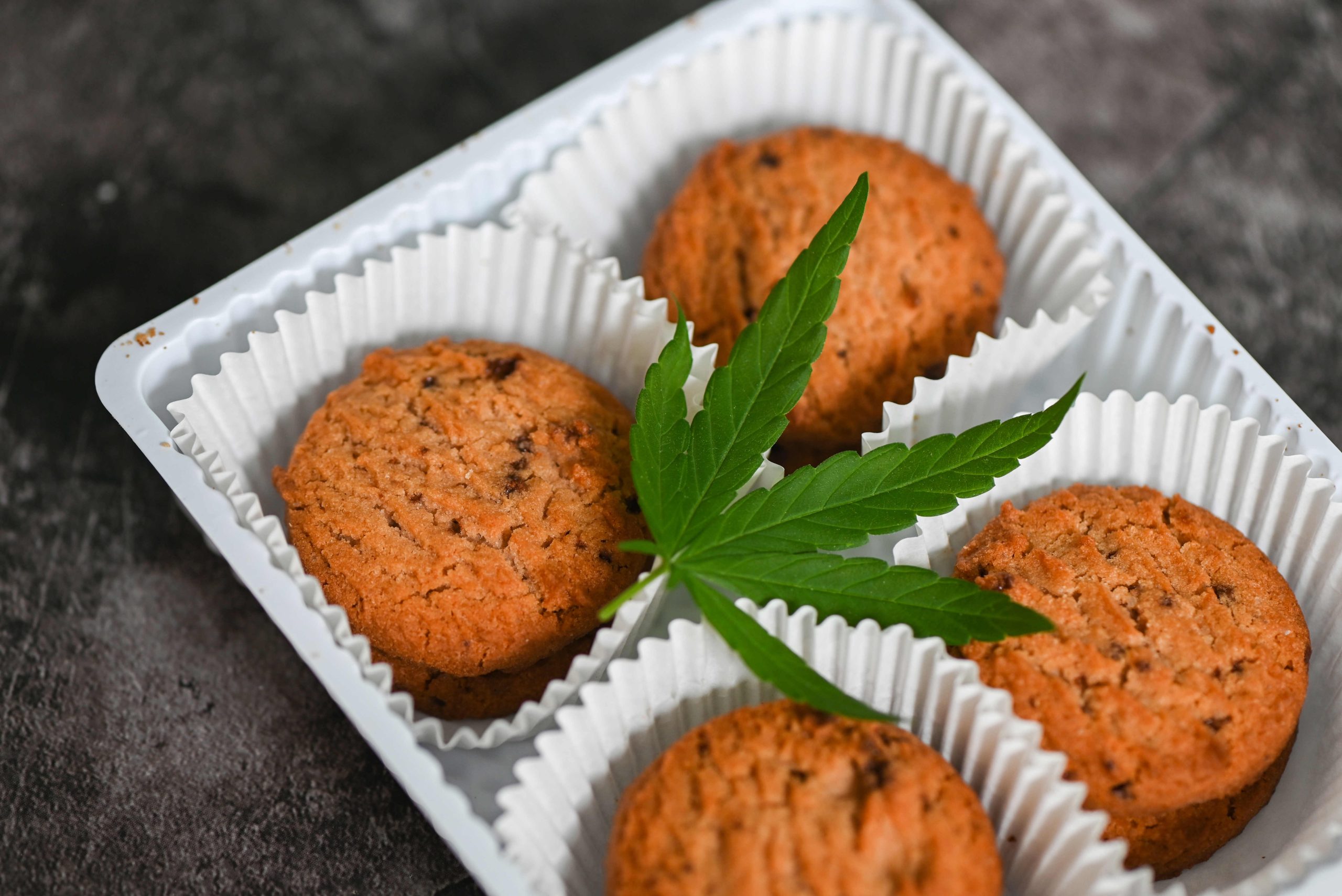 Cannabis food cookies box with cannabis leaf marijuana herb on d